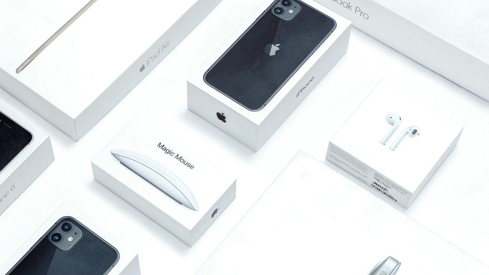 Flat lay of assorted Apple product boxes showcasing technology packaging design.